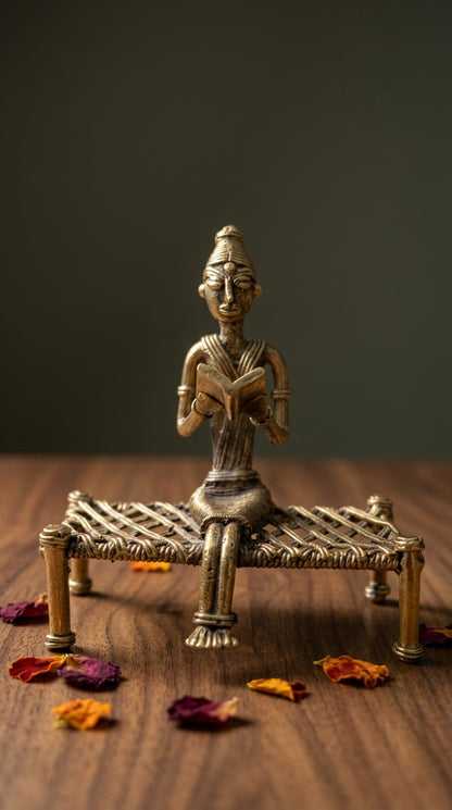 Dhokra Lady Reading on Charpai